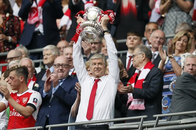 Arsenal team manager Arsene Wenger celebrates with the trophy after winning the English FA Cup final soccer match between Arsenal and Chelsea at Wembley stadium in London, Saturday, May 27, 2017. Arsenal won 2-1. (AP Photo/Kirsty Wigglesworth)