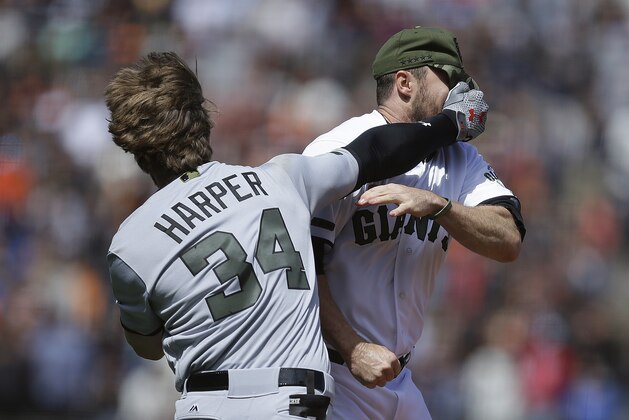 Washington Nationals' Bryce Harper (34) hits San Francisco Giants' Hunter Strickland in the face after being hit with a pitch in the eighth inning of a baseball game Monday, May 29, 2017, in San Francisco. (AP Photo/Ben Margot)