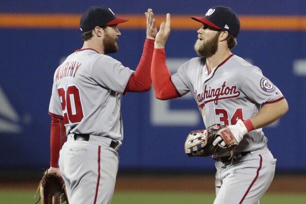 Washington Nationals' Bryce Harper (34) and Daniel Murphy (20) celebrate after a baseball game against the New York Mets, Friday, April 21, 2017, in New York. (AP Photo/Frank Franklin II)