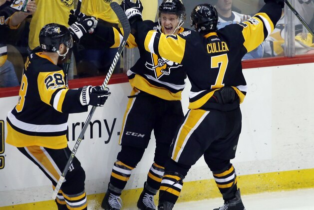 Pittsburgh Penguins' Jake Guentzel, center, celebrates his goal against the Nashville Predators with Ian Cole, left, and Matt Cullen during the third period in Game 1 of the NHL hockey Stanley Cup Finals, Monday, May 29, 2017, in Pittsburgh. (AP Photo/Gene J. Puskar)