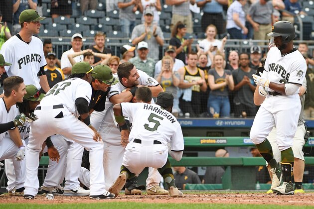 PITTSBURGH, PA - MAY 29:  Andrew McCutchen #22 of the Pittsburgh Pirates is met by teammates at home plate after hitting a walk off home run in the ninth inning to give the Pittsburgh Pirates a 4-3 win over the Arizona Diamondbacks at PNC Park on May 29, 2017 in Pittsburgh, Pennsylvania. MLB players across the league are wearing special uniforms to commemorate Memorial Day. (Photo by Justin Berl/Getty Images)