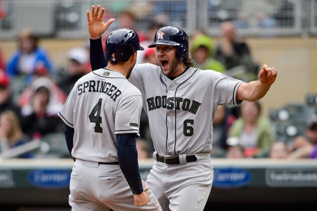 MINNEAPOLIS, MN - MAY 29: George Springer #4 and Jake Marisnick #6 of the Houston Astros celebrate scoring runs against the Minnesota Twins during the game on May 29, 2017 at Target Field in Minneapolis, Minnesota. The Astros defeated the Twins 16-8. (Photo by Hannah Foslien/Getty Images)