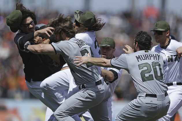 Washington Nationals' Daniel Murphy (20) tries to restrain teammate Bryce Harper (34) after Harper charged  San Francisco Giants' Hunter Strickland after being hit with a pitch in the eighth inning of a baseball game Monday, May 29, 2017, in San Francisco. (AP Photo/Ben Margot)