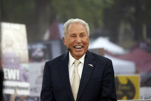 ESPN College GameDay host Lee Corso laughs during the telecast from The Junction prior to Mississippi State playing Auburn in an NCAA college football game in Starkville, Miss., Saturday, Oct 11, 2014. No.3 Mississippi State beat No. 2 Auburn 38-23. (AP Photo/Rogelio V. Solis)