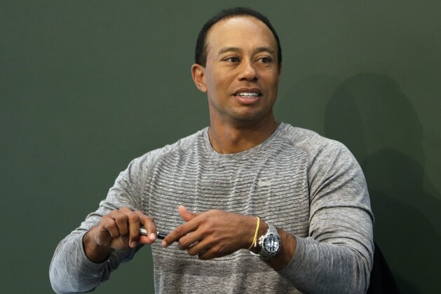 Golfer Tiger Woods prepares to sign copies of his new book at a book signing in New York, Monday, March 20, 2017. (AP Photo/Seth Wenig)