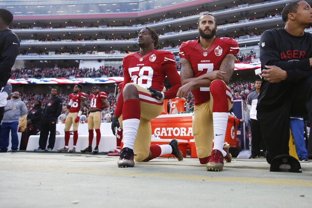SANTA CLARA, CA - JANUARY 1: Eli Harold #58, Colin Kaepernick #7 and Eric Reid #35 of the San Francisco 49ers kneel on the sideline, during the anthem, prior to the game against the Seattle Seahawks at Levi Stadium on January 1, 2017 in Santa Clara, California. The Seahawks defeated the 49ers 25-23. (Photo by Michael Zagaris/San Francisco 49ers/Getty Images)