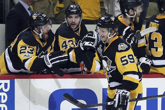 Pittsburgh Penguins' Jake Guentzel (59) celebrates his second goal of the ngiht against the Nashville Predators with teammates Scott Wilson, left, and Conor Sheary, center, during the third period in Game 2 of the NHL hockey Stanley Cup Final, Wednesday, May 31, 2017, in Pittsburgh. (AP Photo/Keith Srakocic)
