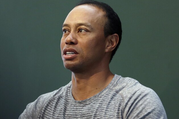 Golfer Tiger Woods prepares to sign copies of his new book at a book signing in New York, Monday, March 20, 2017. (AP Photo/Seth Wenig)