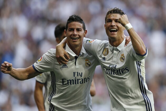 Real Madrid's Cristiano Ronaldo, right, celebrates with teammate James Rodriguez after scoring their side's second goal against Sevilla during the La Liga soccer match between Real Madrid and Sevilla at the Santiago Bernabeu stadium in Madrid, Sunday, May 14, 2017. Ronaldo scored twice in Real Madrid's 4-1 victory. (AP Photo/Francisco Seco)