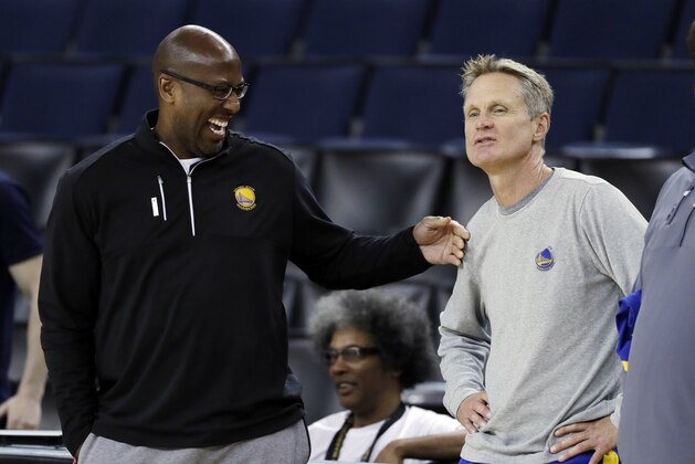 Golden State Warriors head coach Steve Kerr, right, talks with interim head coach Mike Brown during an NBA basketball practice, Wednesday, May 31, 2017, in Oakland, Calif. The Golden State Warriors face the Cleveland Cavaliers in Game 1 of the NBA Finals on Thursday in Oakland. (AP Photo/Marcio Jose Sanchez)