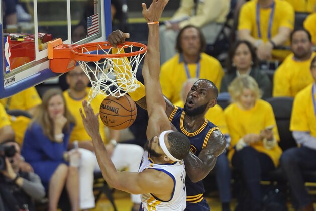 OAKLAND, CA - JUNE 1:  LeBron James #23 of the Cleveland Cavaliers dunks the ball while guarded by JaVale McGee #1 of the Golden State Warriors in Game One of the 2017 NBA Finals on June 1, 2017 at Oracle Arena in Oakland, California. NOTE TO USER: User expressly acknowledges and agrees that, by downloading and or using this photograph, user is consenting to the terms and conditions of Getty Images License Agreement. Mandatory Copyright Notice: Copyright 2017 NBAE (Photo by Joe Murphy/NBAE via Getty Images)