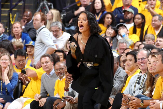 OAKLAND, CA - JUNE 1:  Rihanna cheers from the side line during the game of the Golden State Warriors and the Cleveland Cavaliers in Game One of the 2017 NBA Finals on June 1, 2017 at ORACLE Arena in Oakland, California. NOTE TO USER: User expressly acknowledges and agrees that, by downloading and or using this photograph, user is consenting to the terms and conditions of Getty Images License Agreement. Mandatory Copyright Notice: Copyright 2017 NBAE (Photo by Nathaniel S. Butler/NBAE via Getty Images)