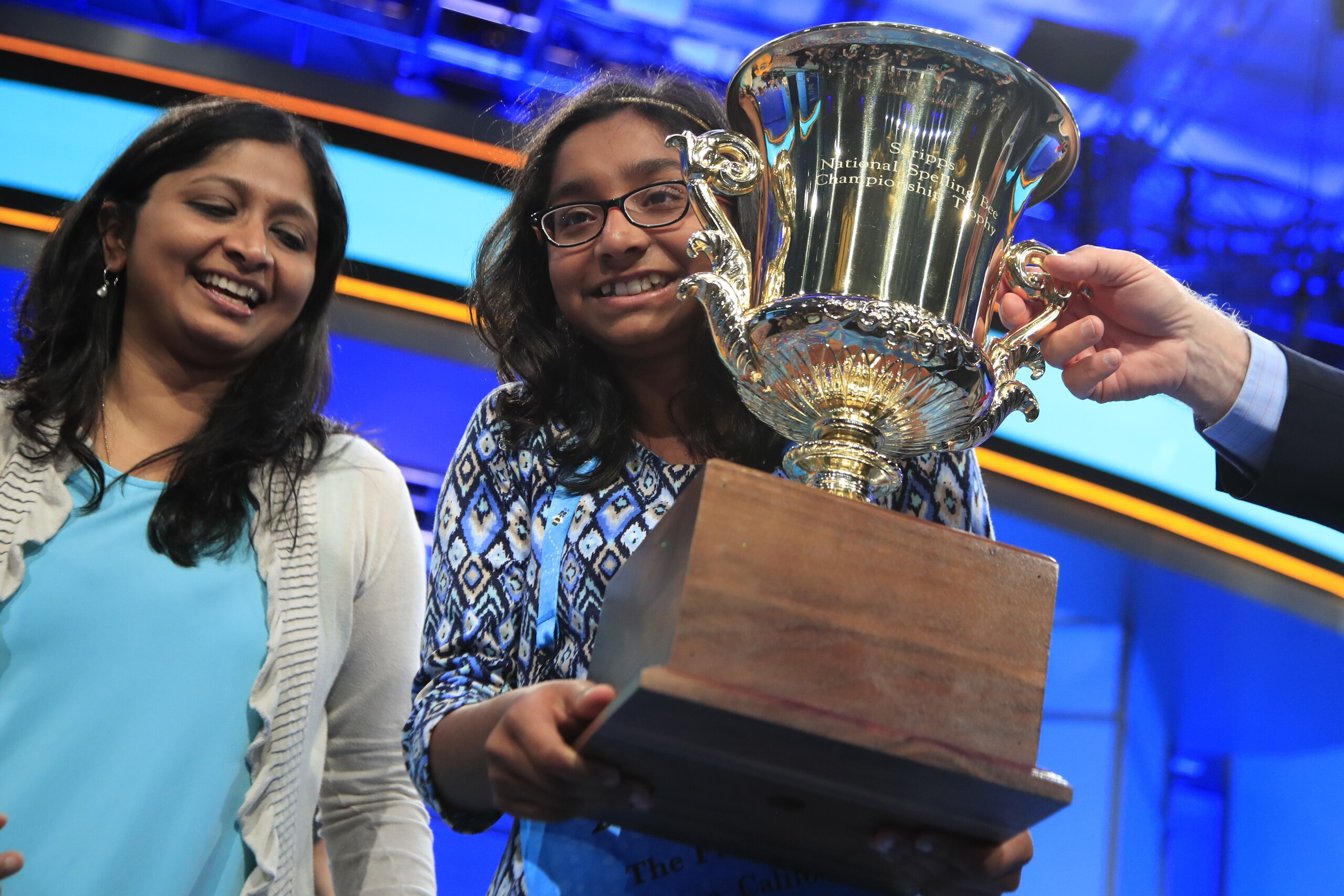 Ananya Vinay, 12, from Fresno, Calif., with her mother, holds her trophy after being declared the winner of the 90th Scripps National Spelling Bee, in Oxon Hill, Md., Thursday, June 1, 2017. (AP Photo/Manuel Balce Ceneta)