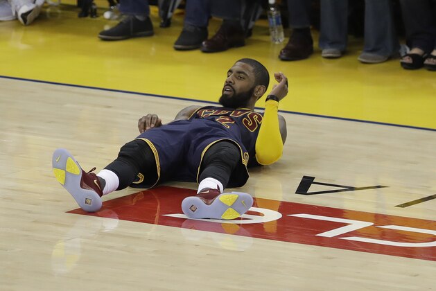 Cleveland Cavaliers guard Kyrie Irving (2) lies on the court during the first half of Game 1 of basketball's NBA Finals against the Golden State Warriors in Oakland, Calif., Thursday, June 1, 2017. (AP Photo/Marcio Jose Sanchez)
