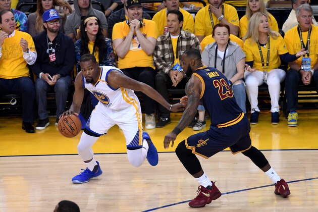 OAKLAND, CA - JUNE 01:  Kevin Durant #35 of the Golden State Warriors drives with the ball against LeBron James #23 of the Cleveland Cavaliers in Game 1 of the 2017 NBA Finals at ORACLE Arena on June 1, 2017 in Oakland, California. NOTE TO USER: User expressly acknowledges and agrees that, by downloading and or using this photograph, User is consenting to the terms and conditions of the Getty Images License Agreement.  (Photo by Thearon W. Henderson/Getty Images)