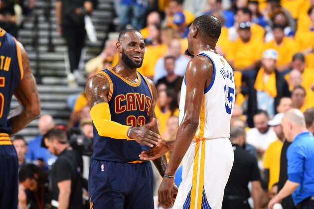 OAKLAND, CA - JUNE 1: LeBron James #23 of the Cleveland Cavaliers and Kevin Durant #35 of the Golden State Warriors high five each other during Game One of the 2017 NBA Finals at Oracle Arena on June 1, 2017 in Oakland, California. NOTE TO USER: User expressly acknowledges and agrees that, by downloading and/or using this Photograph, user is consenting to the terms and conditions of the Getty Images License Agreement. Mandatory Copyright Notice: Copyright 2017 NBAE (Photo by Andrew D. Bernstein/NBAE via Getty Images)