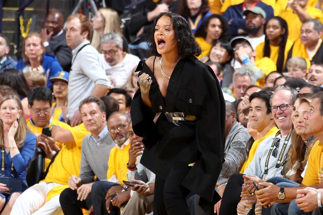 OAKLAND, CA - JUNE 1:  Rihanna cheers from the side line during the game of the Golden State Warriors and the Cleveland Cavaliers in Game One of the 2017 NBA Finals on June 1, 2017 at ORACLE Arena in Oakland, California. NOTE TO USER: User expressly acknowledges and agrees that, by downloading and or using this photograph, user is consenting to the terms and conditions of Getty Images License Agreement. Mandatory Copyright Notice: Copyright 2017 NBAE (Photo by Nathaniel S. Butler/NBAE via Getty Images)