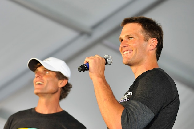 HYANNIS, MA - MAY 30:  NFL quarterback and Best Buddies honorary co-chair Tom Brady (R) speaks on stage with Anthony Shriver at the Finish Line and Victory Celebration Party during the Best Buddies Challenge: Hyannis Port 2015 on May 30, 2015 in Hyannis, Massachusetts.  (Photo by Paul Marotta/Getty Images)
