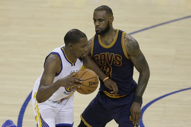 Golden State Warriors forward Kevin Durant, left, drives on Cleveland Cavaliers forward LeBron James during the second half of Game 1 of basketball's NBA Finals in Oakland, Calif., Thursday, June 1, 2017. (AP Photo/Ben Margot)