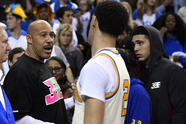 FILE - In this March 4, 2017, file photo, UCLA guard Lonzo Ball, right, shakes hands with his father LaVar following an NCAA college basketball game against Washington State in Los Angeles. UCLA won 77-68. LaVar Ball told Southern California News Group for a story published online on April 6, 2017, that UCLA was eliminated in the NCAA tournament because “three white guys” couldn’t pick up the slack after his son suffered a hamstring injury. (AP Photo/Mark J. Terrill, File)