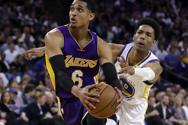 Los Angeles Lakers' Jordan Clarkson (6) dribbles past Golden State Warriors' Patrick McCaw during the first half of an NBA basketball game, Wednesday, April 12, 2017, in Oakland, Calif. (AP Photo/Marcio Jose Sanchez)