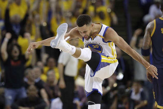 Golden State Warriors guard Stephen Curry (30) reacts after scoring against the Cleveland Cavaliers during the second half of Game 1 of basketball's NBA Finals in Oakland, Calif., Thursday, June 1, 2017. (AP Photo/Marcio Jose Sanchez)