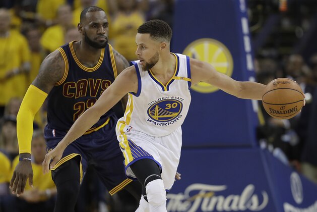 Golden State Warriors guard Stephen Curry (30) is guarded by Cleveland Cavaliers forward LeBron James during the second half of Game 1 of basketball's NBA Finals in Oakland, Calif., Thursday, June 1, 2017. (AP Photo/Marcio Jose Sanchez)
