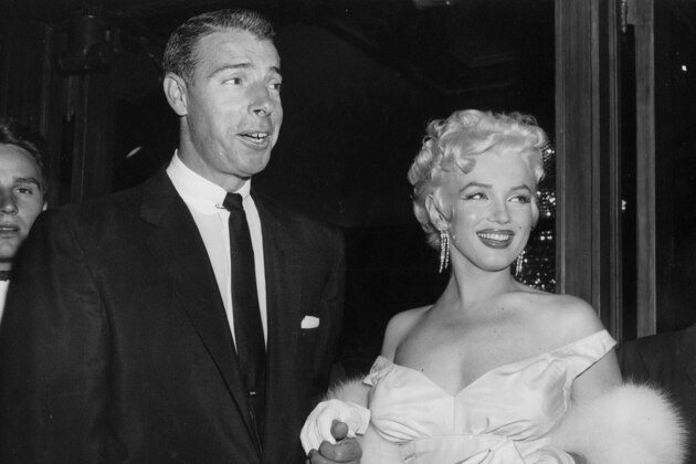 FILE - In this June 2, 1955 file photo, actress Marilyn Monroe, right, dressed in a glamorous evening gown, arrives with Joe DiMaggio at the theater.  DiMaggio's love letter to Marilyn Monroe has sold for $78,125 at a Beverly Hills auction. Julien's Auctions in Beverly Hills says the letter, written by the baseball great after Monroe announced she was divorcing him, was sold Saturday, Dec. 6, 2014, to an undisclosed buyer.(AP Photo, File)