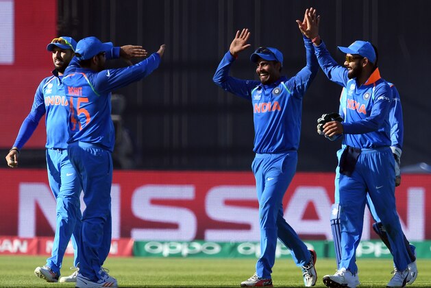 India's Umesh Yadav (2R) celebrates the wicket of Pakistan's Shoaib Malik with teammates during the ICC Champions trophy match between India and Pakistan at Edgbaston in Birmingham on June 4, 2017. / AFP PHOTO / Paul ELLIS / RESTRICTED TO EDITORIAL USE        (Photo credit should read PAUL ELLIS/AFP/Getty Images)