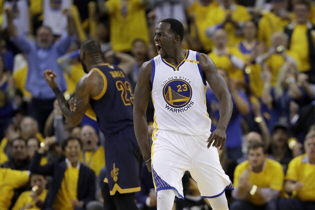 Golden State Warriors forward Draymond Green, foreground, reacts in front of Cleveland Cavaliers forward LeBron James during the second half of Game 1 of basketball's NBA Finals in Oakland, Calif., Thursday, June 1, 2017. (AP Photo/Marcio Jose Sanchez)
