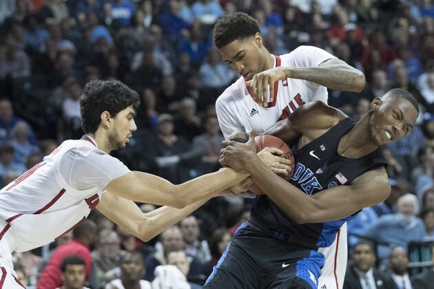 Duke forward Harry Giles, right, fights for a rebound against Louisville forward Ray Spalding, second from right, and Louisville forward Anas Mahmoud during the second half of an NCAA college basketball game in the Atlantic Coast Conference tournament, Thursday, March 9, 2017, in New York. Duke won 81-77. (AP Photo/Mary Altaffer)