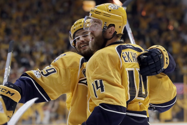 Nashville Predators defenseman Mattias Ekholm (14), of Sweden, celebrates his goal against the Pittsburgh Penguins with defenseman Roman Josi (59), of Switzerland, during the third period in Game 3 of the NHL hockey Stanley Cup Finals Saturday, June 3, 2017, in Nashville, Tenn. (AP Photo/Mark Humphrey)