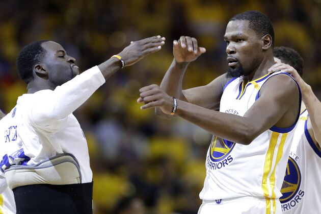 Golden State Warriors forward Kevin Durant, center, celebrates with Draymond Green, left, and Klay Thompson during the second half of Game 2 of basketball's NBA Finals against the Cleveland Cavaliers in Oakland, Calif., Sunday, June 4, 2017. (AP Photo/Marcio Jose Sanchez)