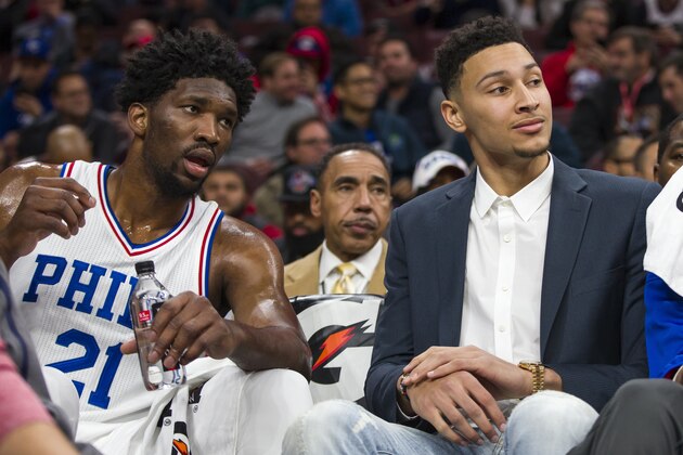 Philadelphia 76ers center Joel Embiid, left, looks on from the bench with Ben Simmons, right, during the first half of an NBA basketball game against the Toronto Raptors, Wednesday, Dec. 14, 2016, in Philadelphia. The Raptors won 123-114. (AP Photo/Chris Szagola)