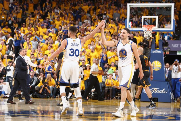 OAKLAND, CA - JUNE 4:  Stephen Curry #30 and Klay Thompson #11 of the Golden State Warriors high five during the game against the Cleveland Cavaliers in Game Two of the 2017 NBA Finals on June 4, 2017 at ORACLE Arena in Oakland, California. NOTE TO USER: User expressly acknowledges and agrees that, by downloading and or using this photograph, user is consenting to the terms and conditions of Getty Images License Agreement. Mandatory Copyright Notice: Copyright 2017 NBAE (Photo by Nathaniel S. Butler/NBAE via Getty Images)
