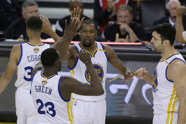 Golden State Warriors forward Kevin Durant, center, celebrates with guard Stephen Curry, top left, forward Draymond Green (23) and center Zaza Pachulia during the second half of Game 2 of basketball's NBA Finals against the Cleveland Cavaliers in Oakland, Calif., Sunday, June 4, 2017. (AP Photo/Ben Margot)