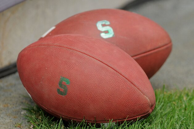 EAST LANSING, MI - SEPTEMBER 04:  A pair of footballs sit on the field before the game between the Michigan State Spartans and the Western Michigan Broncos at Spartan Stadium on September 4, 2010 in East Lansing, Michigan.  (Photo by Mark Cunningham/Getty Images)