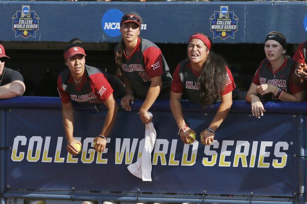 Oklahoma players cheer in the dugout in the first inning of the first game of the best-of-three championship series against Florida in the NCAA Women's College World Series in Oklahoma City, Monday, June 5, 2017. (AP Photo/Sue Ogrocki)
