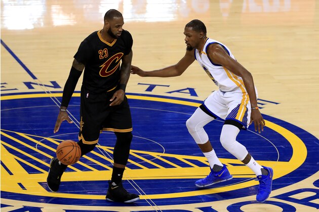 OAKLAND, CA - JUNE 04: LeBron James #23 of the Cleveland Cavaliers is defended by Kevin Durant #35 of the Golden State Warriors during the second half of Game 2 of the 2017 NBA Finals at ORACLE Arena on June 4, 2017 in Oakland, California. NOTE TO USER: User expressly acknowledges and agrees that, by downloading and or using this photograph, User is consenting to the terms and conditions of the Getty Images License Agreement.  (Photo by Ronald Martinez/Getty Images)