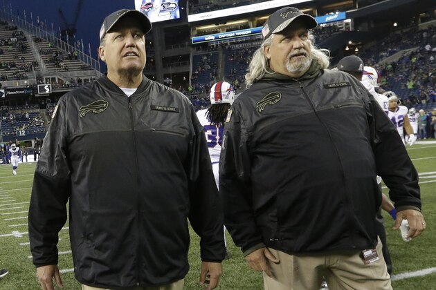 Buffalo Bills head coach Rex Ryan, left, stands with his twin brother, Rob Ryan, right, assistant head coach - defence, during warmups before an NFL football game against the Seattle Seahawks, Monday, Nov. 7, 2016, in Seattle. (AP Photo/Elaine Thompson)
