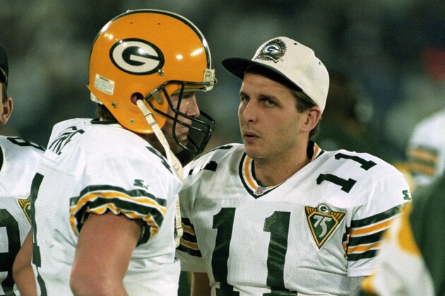 Green Bay Packers quarterback Brett Favre (4) talks to backups Mark Brunell (8) and Ty Detmer (11) during the NFL Wildcard Playoff, a 28-24 victory over the Detroit Lions on January 8, 1994, at the Pontiac Silverdome in Pontiac, Michigan. (Photo by Betsy Peabody Rowe/Getty Images)