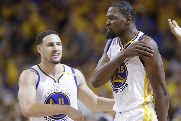 Golden State Warriors forward Kevin Durant, (35) celebrates with Klay Thompson during the second half of Game 2 of basketball's NBA Finals against the Cleveland Cavaliers in Oakland, Calif., Sunday, June 4, 2017. (AP Photo/Marcio Jose Sanchez)