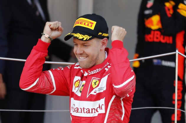 Ferrari driver Sebastian Vettel of Germany celebrates on the podium after winning the Formula One Grand Prix at the Monaco racetrack in Monaco, Sunday, May 28, 2017. (AP Photo/Frank Augstein)