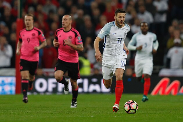 England's midfielder Adam Lallana (R) runs with the ball during a World Cup 2018 qualification match between England and Scotland at Wembley stadium in London on November 11, 2016. / AFP / Adrian DENNIS / NOT FOR MARKETING OR ADVERTISING USE / RESTRICTED TO EDITORIAL USE
        (Photo credit should read ADRIAN DENNIS/AFP/Getty Images)
