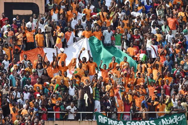 Ivory Coast's team supporters hold the Ivorian flag at the Felix Houphouet-Boigny Stadium in Abidjan on November 19, 2014 during the 2015 Africa Cup of Nations group D qualifying football match between Ivory Coast and Cameroon. AFP PHOTO / ISSOUF SANOGO        (Photo credit should read ISSOUF SANOGO/AFP/Getty Images)