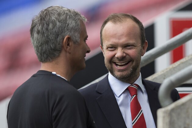 Manchester United's executive vice-chairman Ed Woodward (R) reacts as he talks with Manchester United's Portuguese manager Jose Mourinho folowing the pre-season friendly football match between Wigan Athletic and Manchester United at the DW stadium in Wigan, northwest England, on July 16, 2016.  / AFP / JON SUPER / RESTRICTED TO EDITORIAL USE. No use with unauthorized audio, video, data, fixture lists, club/league logos or 'live' services. Online in-match use limited to 75 images, no video emulation. No use in betting, games or single club/league/player publications.  /         (Photo credit should read JON SUPER/AFP/Getty Images)