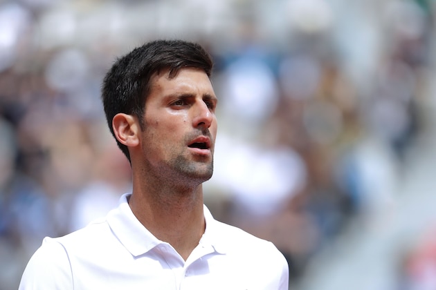 Serbia's Novak Djokovic reacts during his tennis match against Austria's Dominic Thiem at the Roland Garros 2017 French Open on June 7, 2017 in Paris.  / AFP PHOTO / Thomas SAMSON        (Photo credit should read THOMAS SAMSON/AFP/Getty Images)