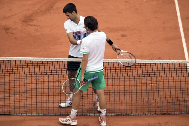 Jun 7, 2017; Paris, France; Dominic Thiem (AUT) at the net with Novak Djokovic (SRB) after their match on day eleven of the 2017 French Open tennis tournament at Stade Roland Garros. Mandatory Credit: Susan Mullane-USA TODAY Sports