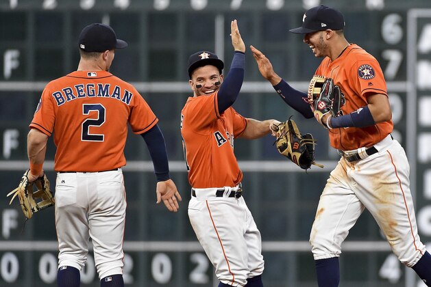 Houston Astros' Jose Altuve, center, Carlos Correa, right, and Alex Bregman (2) celebrate their win over the Baltimore Orioles in a baseball game, Friday, May 26, 2017, in Houston. (AP Photo/Eric Christian Smith)