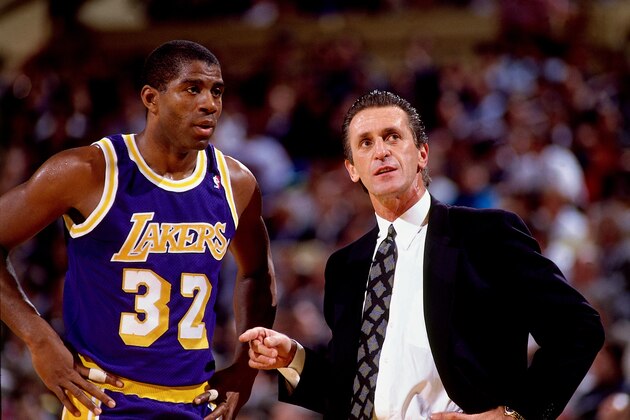 NEW YORK - 1990:  Magic Johnson #32 of the Los Angeles Lakers talks with head coach Pat Riley during a game against the New York Knicks, circa 1990 at Madison Square Garden in New York, New York.  NOTE TO USER: User expressly acknowledges that, by downloading and or using this photograph, User is consenting to the terms and conditions of the Getty Images License agreement. Mandatory Copyright Notice: Copyright 1990 NBAE (Photo by Nathaniel S. Butler/NBAE via Getty Images)